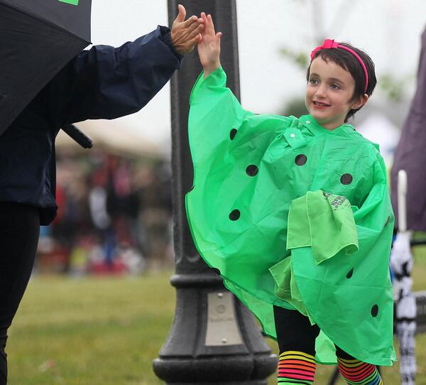 Abbey Sauve, a 6-year-old cancer survivor gets a high five while taking part in the Relay for Life in LaSalle.