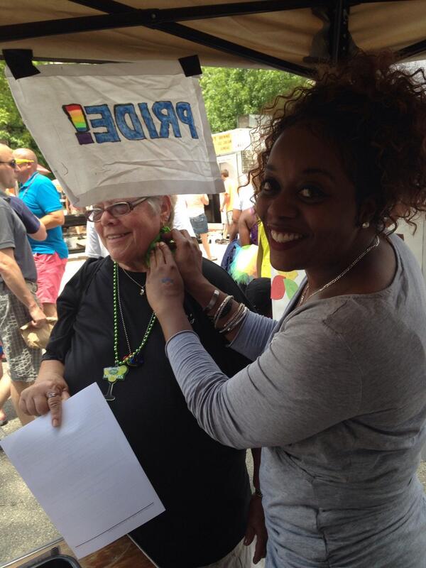 CRC member Chavon Watt applying our Star of David temporary tattoo to a booth visitor. #STLPride