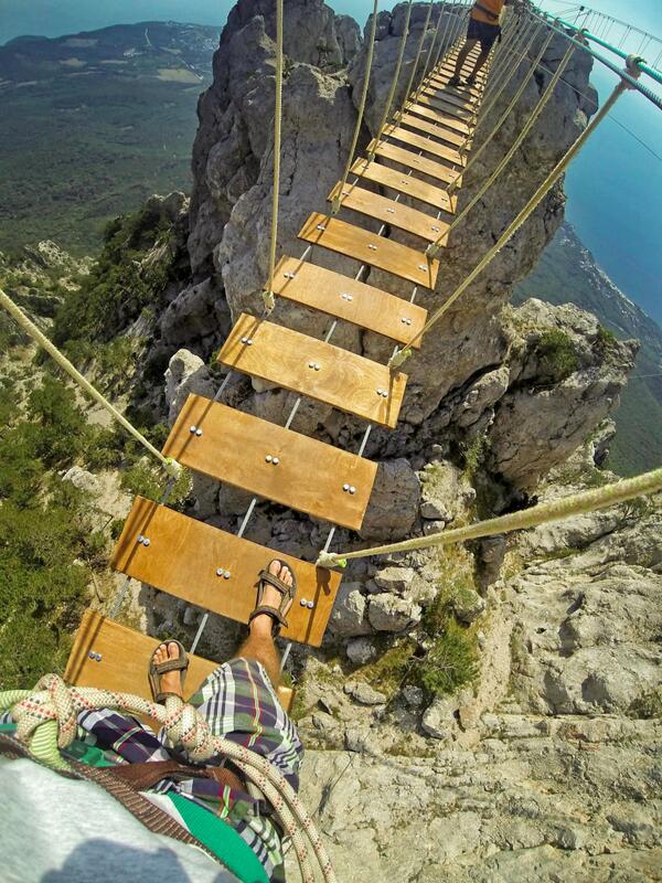 GoPro's tweet photo. Photo of the Day! Don't look down. Crossing rope bridges on Aypetry mountain in the Ukraine. Photo by Dmitry Sivolap. http://t.co/TkY0Dbx94Q