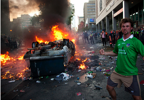 ballsdotie's tweet photo. Happy Canada Day - here's a photo of a man in a Limerick jersey at the 2011 Vancouver Riots - http://t.co/Y936YhYeSW http://t.co/1PGvQcplBH