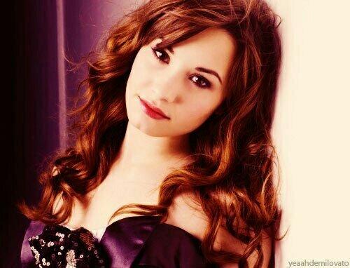 Sierra leaned on the wall of a building looking at her phone pushing her hair b out of her face. #OpenRp