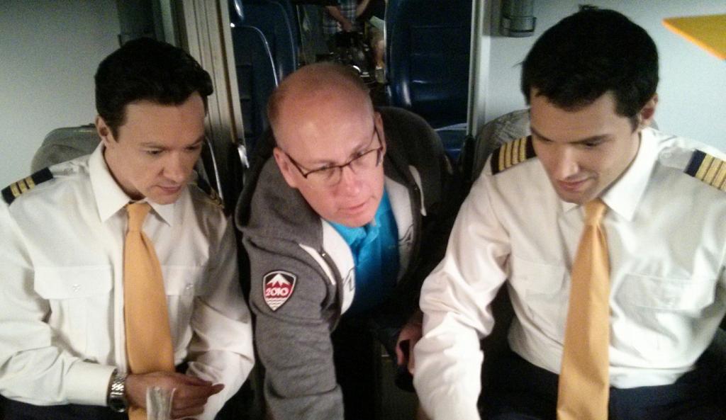 Henry Judge, Dave Dawson and Samy Osman on set of Mayday - The pretend pilots Henry and Samy reviving instructions from real life pilot Dave.