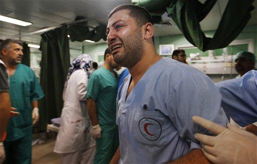 screamingtamimi's tweet photo. A Palestinian medic is overwhelmed by emotion as he takes a break treating wounded people by Israeli strikes in Gaza. http://t.co/ONCZMGwjAU