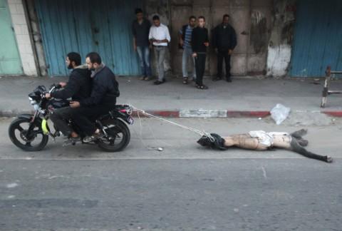 TarekFatah's tweet photo. Hamas dragging the body of a fellow Palestinian through streets of Gaza City. He was accused of being an Israeli spy. http://t.co/joPVsCLv5q