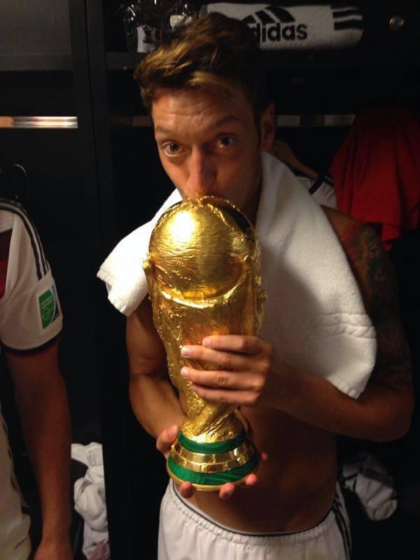 Mesut Ozil celebrating with the world cup in German dressing room.