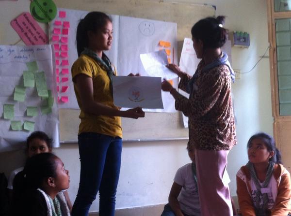 Cambodia_GOLD's tweet photo. Today Becky and Heather lead a session on PR and marketing. Including creating a flag represent guiding in Cambodia. http://t.co/m7q8zpRimH
