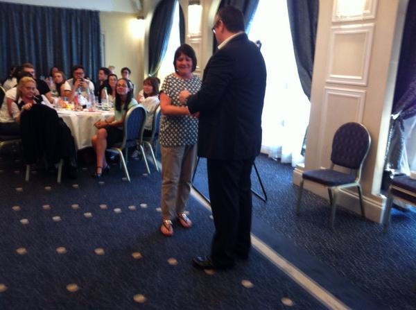 Mary receiving a reward off phil woodhouse for 25 years service