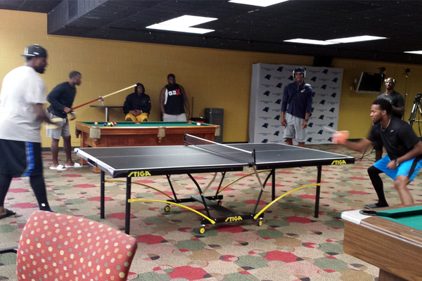 Panthers's tweet photo. '@CameronNewton watches as @kk_mr93 and @J_No24 play ping pong as @Harp41 shoots pool in the background. #CampLife http://t.co/z9Rvk8OiiQ