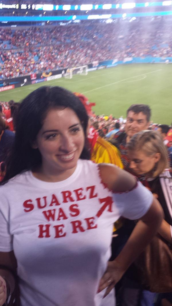 BuMn10UIAAIX0fT Liverpool footy fan shows off her new Suarez was here T shirt, complete with bite marks 