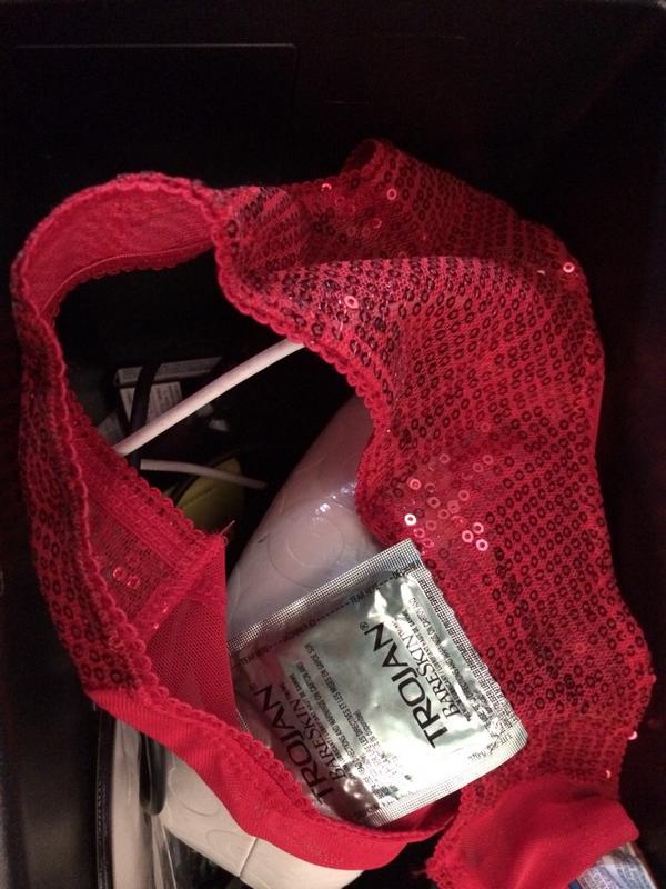 saintbarabbas's tweet photo. Contents of my wife's car console ... red underwear and a condom.  Hmmm.... http://t.co/QTjP8tBhUZ