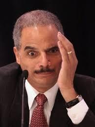 Eric Holder tells students in Ferguson he's a victim of racial profiling.