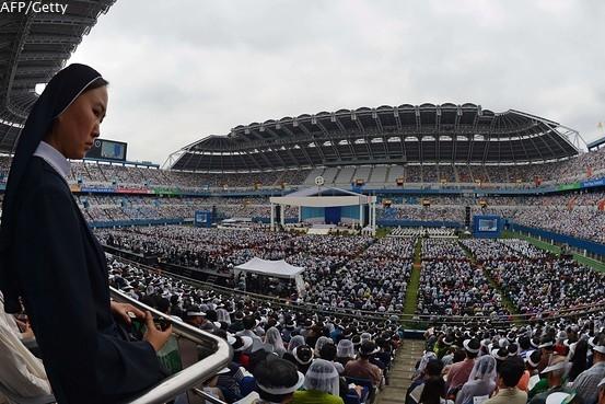 WSJ's tweet image. Pope Francis holds first public mass at one of South Korea's World Cup stadiums on.wsj.com/VoOjor