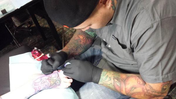 QoH_Tattoos's tweet photo. One of our artists, Tyler tattooing on the first day of this @TattooYouMN convention! http://t.co/0d3qhgTTer