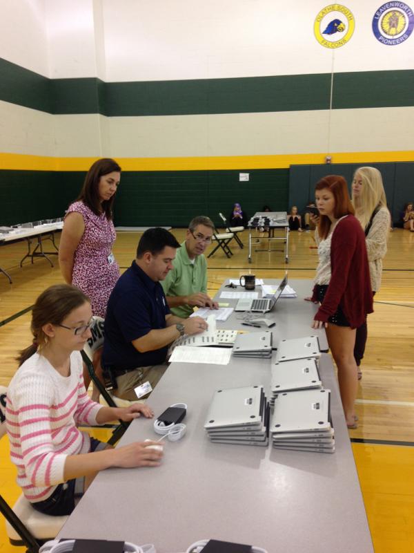 SM South students receiving their new MacBook Airs from principal Dr. Joe Gilhaus and company.