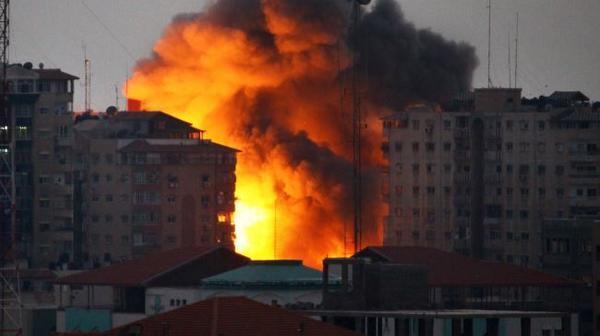 PressTV's tweet photo. #Israel bombs #Gaza 12-story tower http://t.co/Ekk3nMBlg1 #GazaUnderAttack http://t.co/fLEFc03aXI