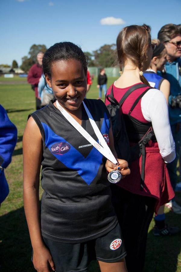 NMFCHuddle's tweet photo. Robel moved to Melbourne from Ethiopia 2 years ago. On Saturday she played in her first @AFL GF @OfficialMUGARS http://t.co/2YvU6EfOwx