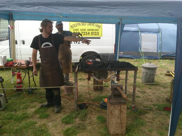 hackerfantastic's tweet photo. Blacksmith workshops are in place again at #emcamp this year and proving hugely popular! http://t.co/s9mm6AVhqr