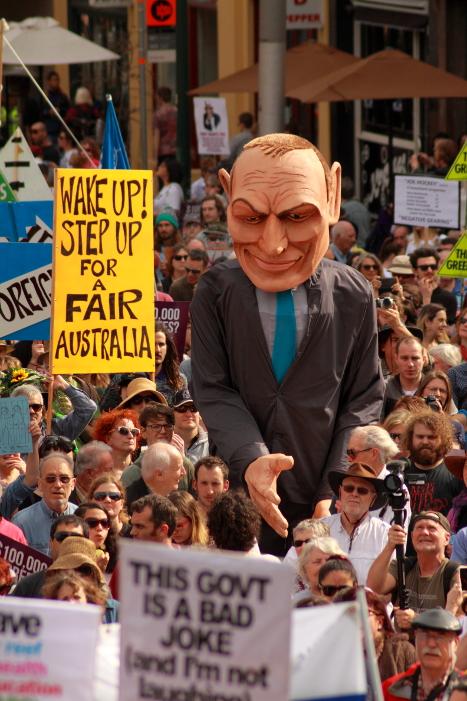 Jansant's tweet photo. Tony Abbott standing over the masses at #MarchInAugust #Melbourne #NoFibs #auspol http://t.co/QmQyEknTUX