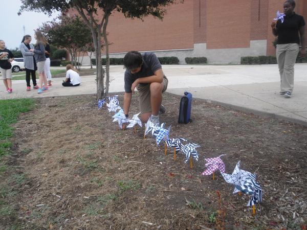 ARTrcms's tweet photo. Students adding pinwheels for the display in front of our school. http://t.co/b3vO1xjvIS