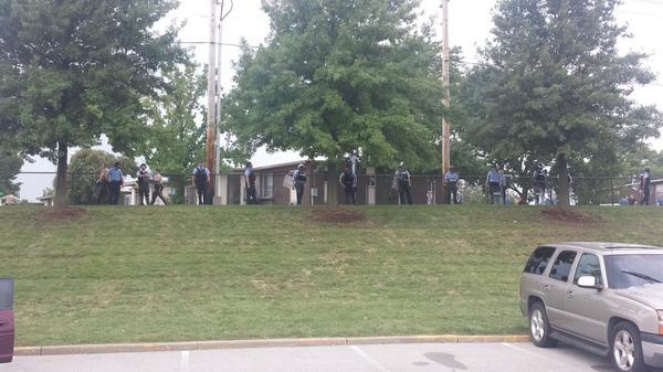 D_Towski's tweet photo. Riot cops are back, forming up in parking lot. #Ferguson http://t.co/z1mDR80lcy