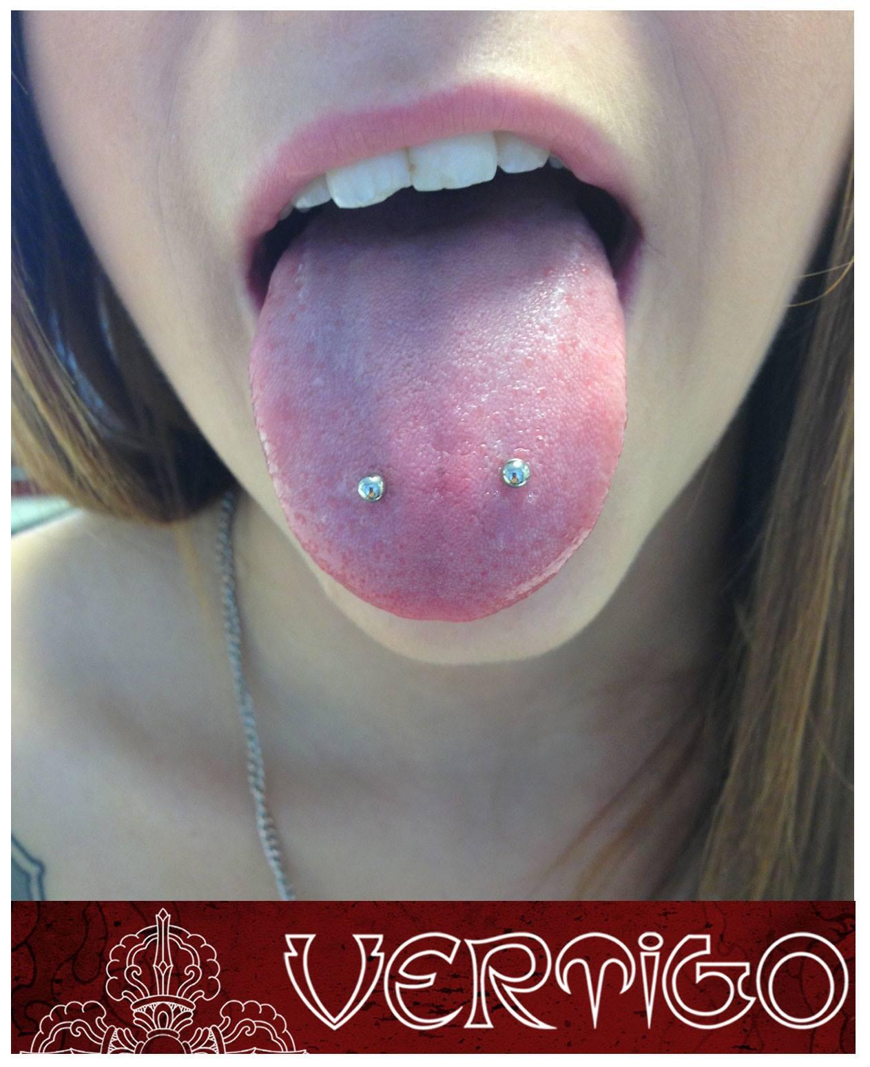 X Vertigo Tattoo Horizontal Tongue Piercing done