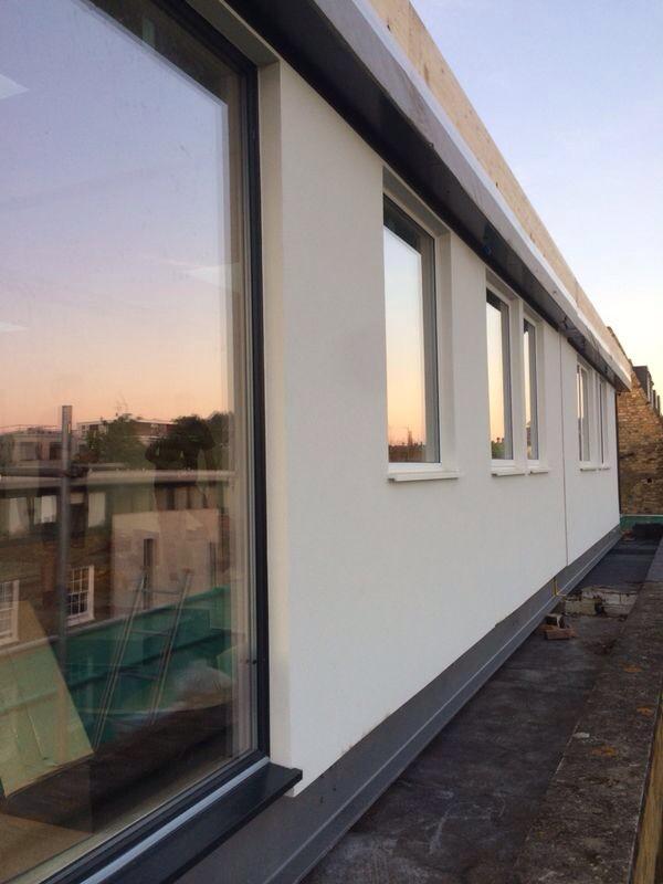 The slightly mirrored triple glazing reflects the sun setting over the #London #skyline.