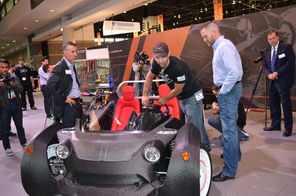 HurTBurtT's tweet photo. @localmotors motors CEO Jay Rogers and @amtonline president Doug Woods prepare to drive the #3DPrintedCar! #IMTS2014 http://t.co/C9e5M9A3B1