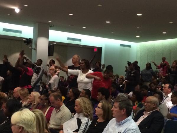 FoCoCopblock's tweet image. "@KMOVMatt: Crowd chanting , "Arrest Darren Wilson" at St Louis County Council meeting. #kmov http://t.co/fxJhrfhUwm"