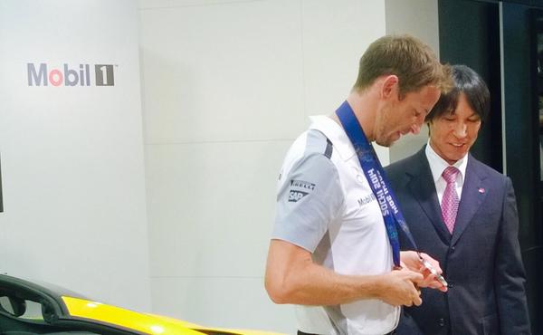 McLarenF1's tweet photo. JB dons Olympic ski jumper Noriaki Kasai’s gold medal in Tokyo last night. #NiceBling #Mobil1Insider #JapaneseGP http://t.co/SrKJfpw4KM
