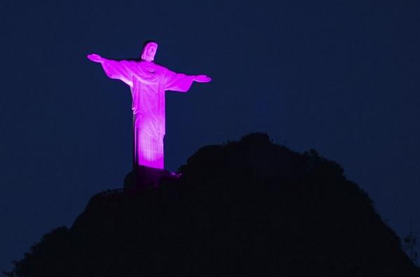 Statue of Christ the Redeemer, illuminated with pink. October Rose for the breast cancer awareness in Rio de Janeiro.