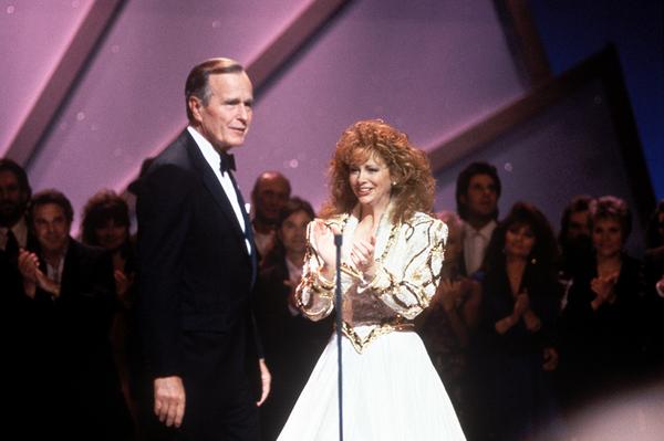 KIX106's tweet photo. RT @CountryMusic: #ThisDayInCountry GW Bush becomes first president to attend the #CMAawards (hosted by @reba) (1991) http://t.co/X7VD3Jhmip