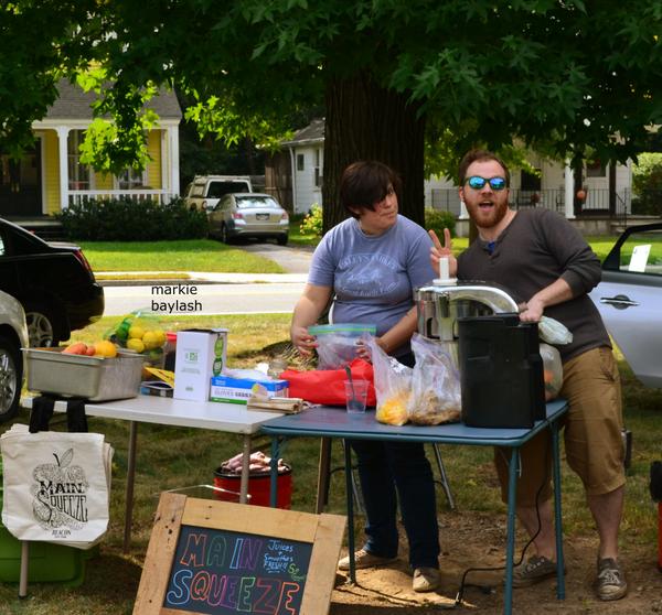 The Main Squeeze crew serving cold fresh juice .