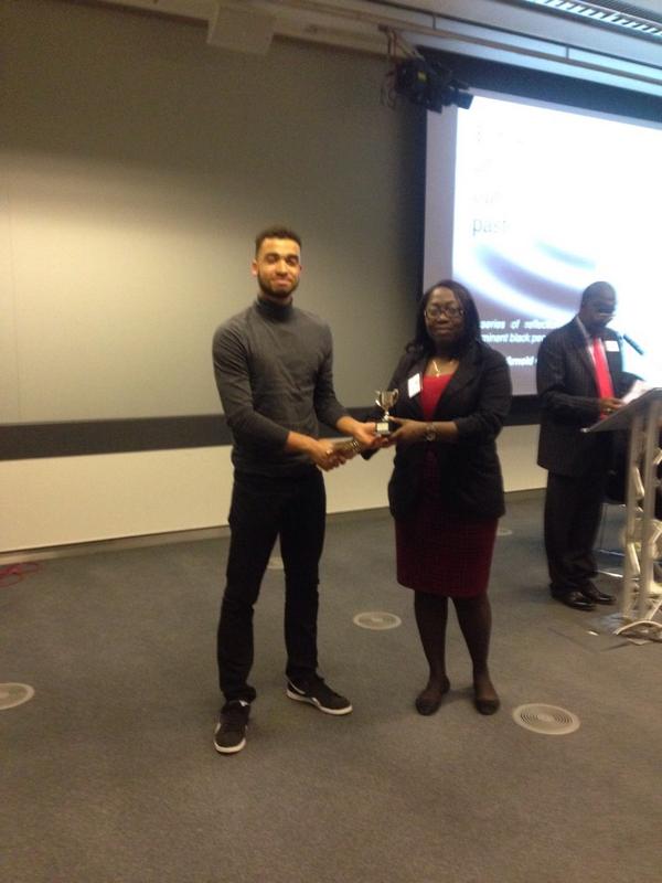 The male winner is the fab Harlan Davies who has roots in Grenada. Teisha presents the trophy