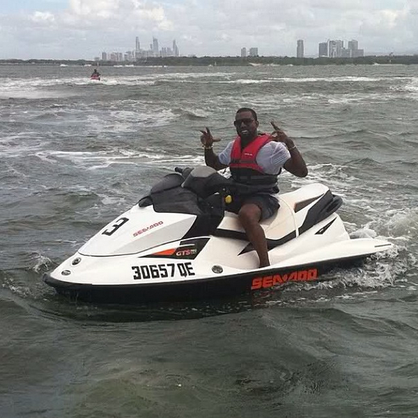 KanyeDoingThing's tweet photo. Kanye posing on a jet ski. http://t.co/njrChkAIEH