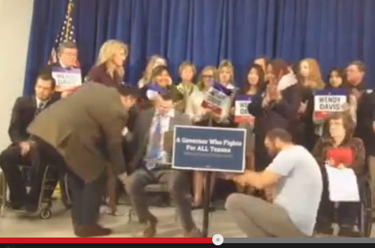 Wendy Davis staffer dragged disabled man across stage in a chair. VIDEO