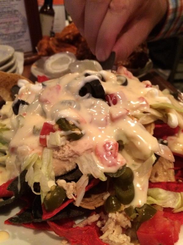 Action shot of <a href="/Zimmerman/">David Zimmerman 🌻🏀</a> digging into the queso nachos #cltweetup
