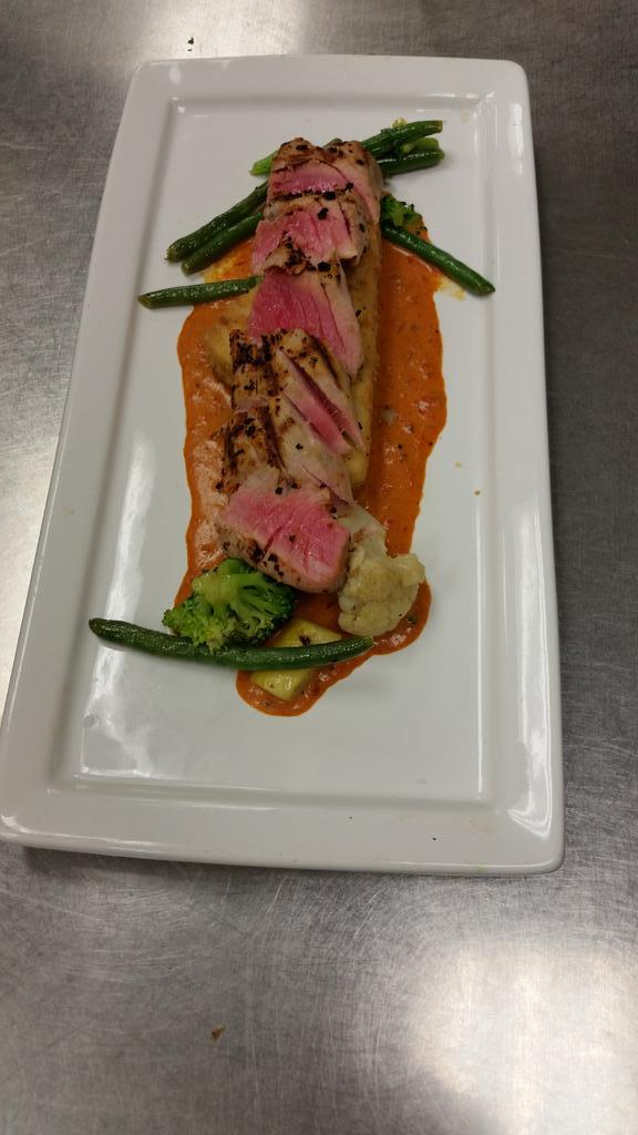 Ancho grilled ahi tuna with a crispy grit cake, vegatables, and roasted pepper and Chipotle cream sauce tonight!