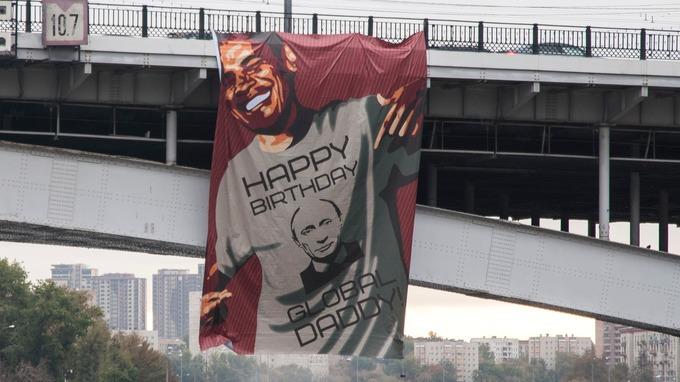 Banner on Moscow bridge shows Obama wishing happy birthday to global daddy Vladimir Putin
 