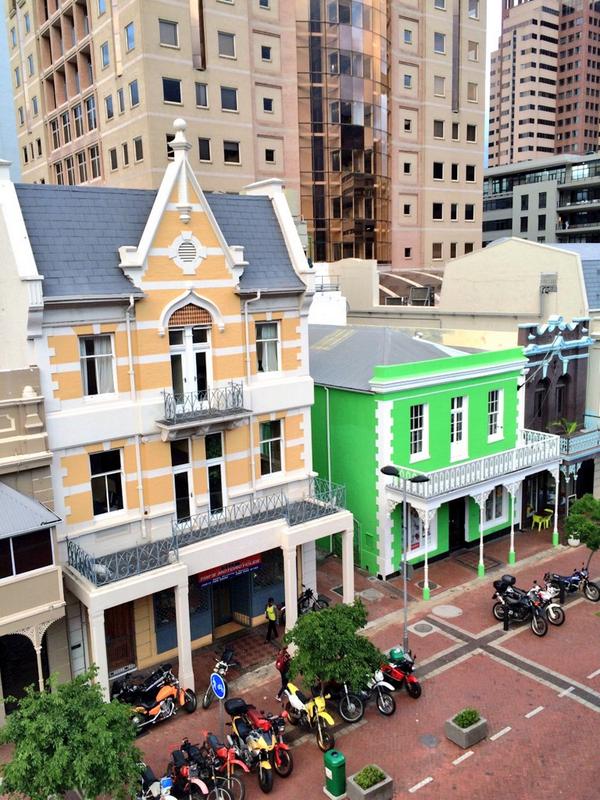 DawnJorgensen's tweet photo. A look down on Waterkant St. Cape architecture, bright colours, bikes, cobbled walkway. This is my city. #BANFF2014 http://t.co/z3FtNO7zA7