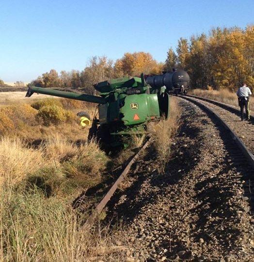 James_Stacey_'s tweet photo. Oh #deere what has happened here!! Via @WOatway: Scary!  Train and combine by Lacombe. http://t.co/BST9CnAAhe