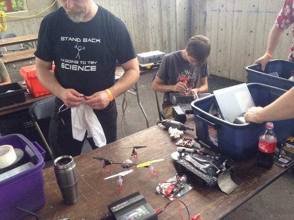 FootPoundForce's tweet image. Jason from #RobotBattles showing off his hardware and prodigious use of duck tape.  @MakerFaireChatt