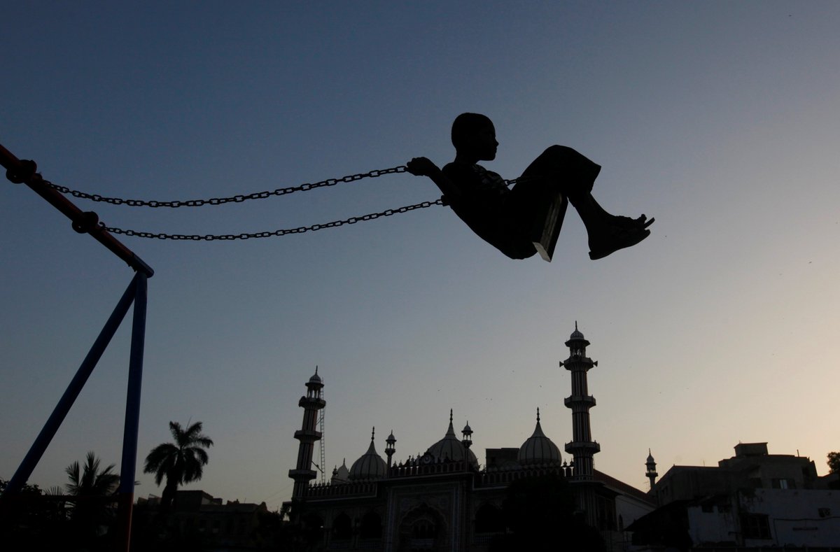 instantmatch's tweet image. A boy plays on a swing during sunset hours near a mosque in Karachi, Pakistan April 21, 2017. @NadeemAkhtarSo1 @reuterspictures