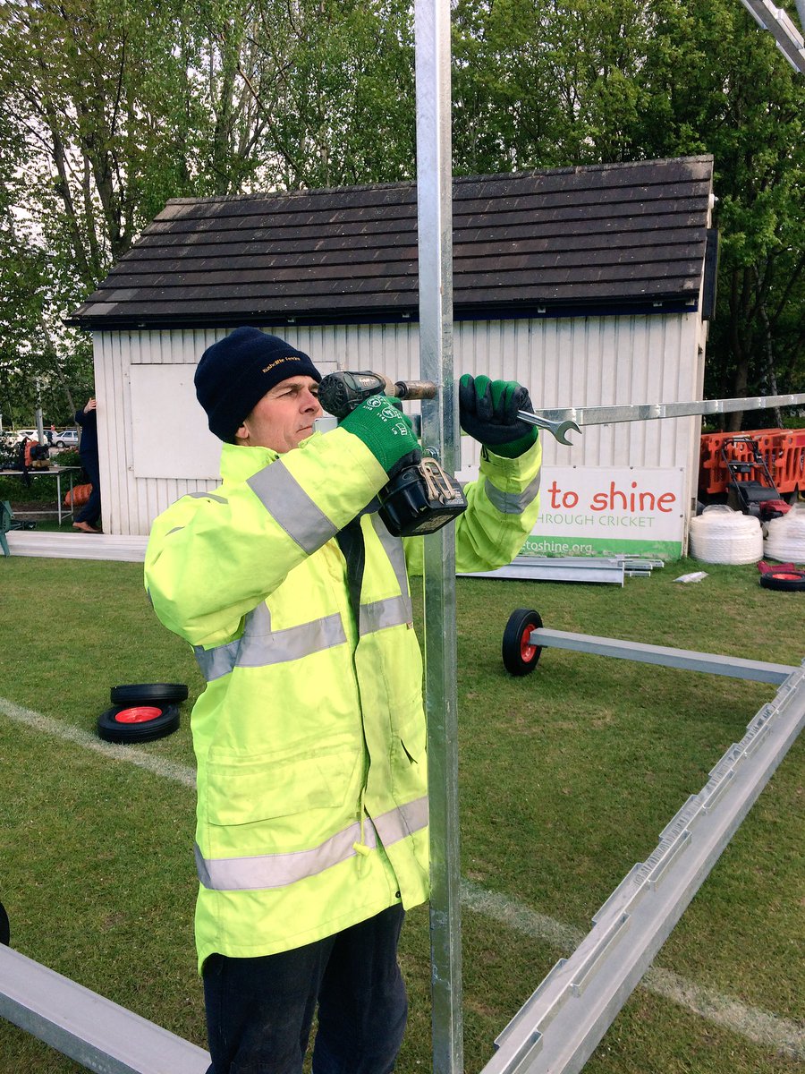 Top man on the job here! R. J. Harrison making quick work of the new sight screens. 
Alastair watching, hands in pockets - barking orders!
