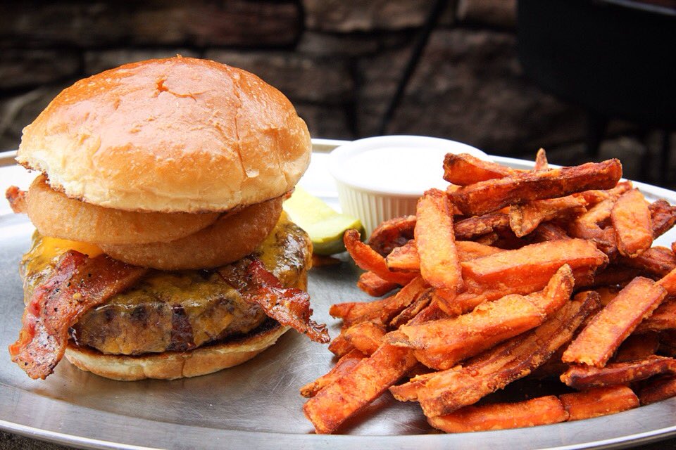Our #BBQ #burger smothered in BBQ sauce &amp; topped with three-pepper #bacon, cheddar cheese, &amp; onion rings! #YUM