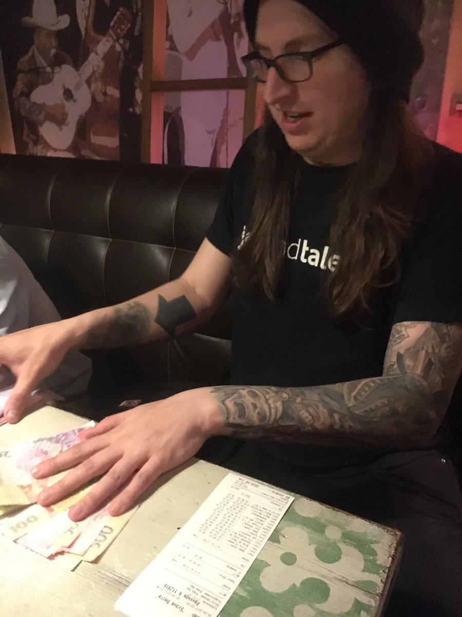 Steve Klabnik counting money at a bar to make sure the bill fits.