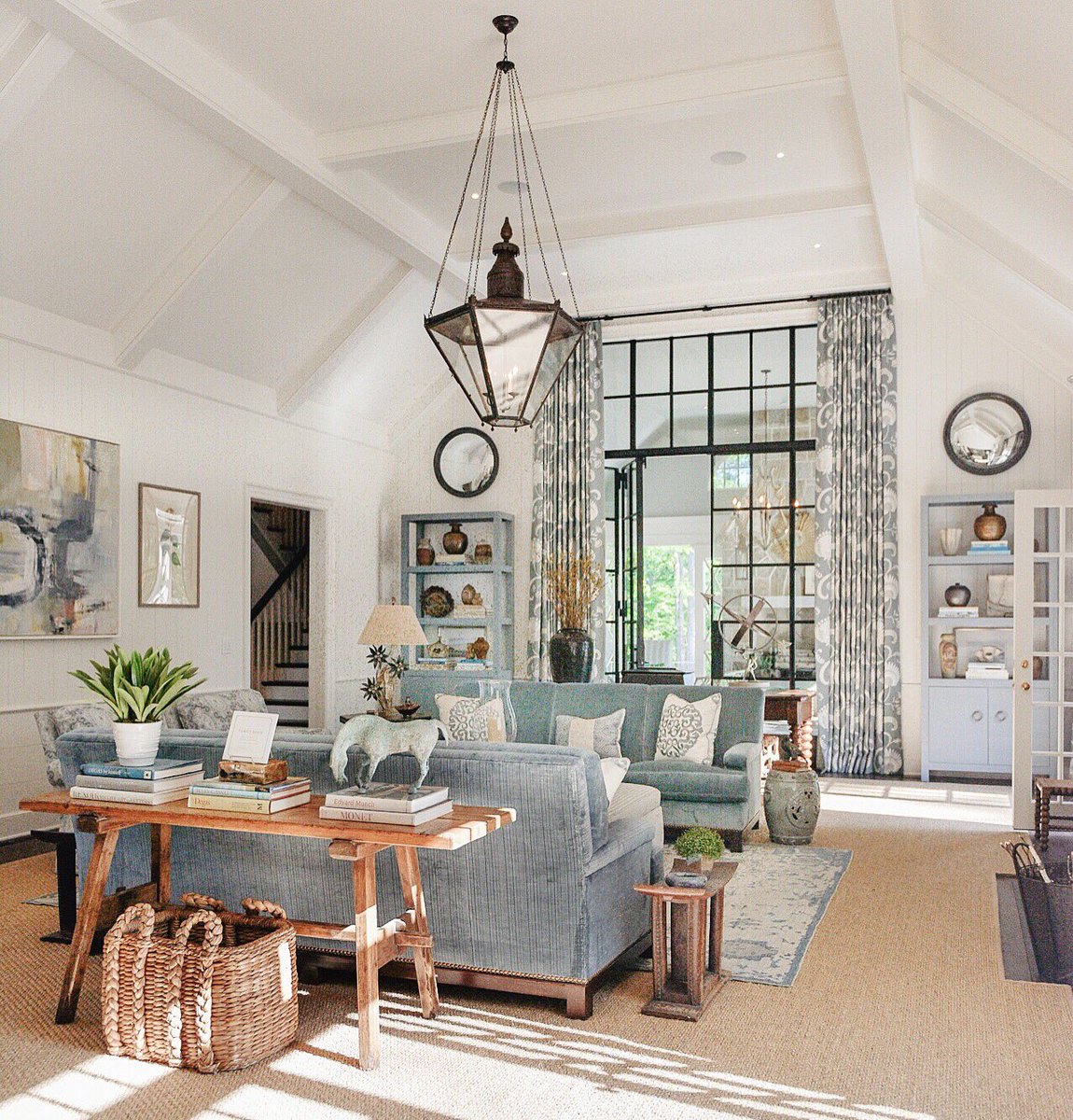 Blue decor in living room with steel and glass doors and transom. Southeastern Designer Show House. #livingroom #lantern #decorinspiration