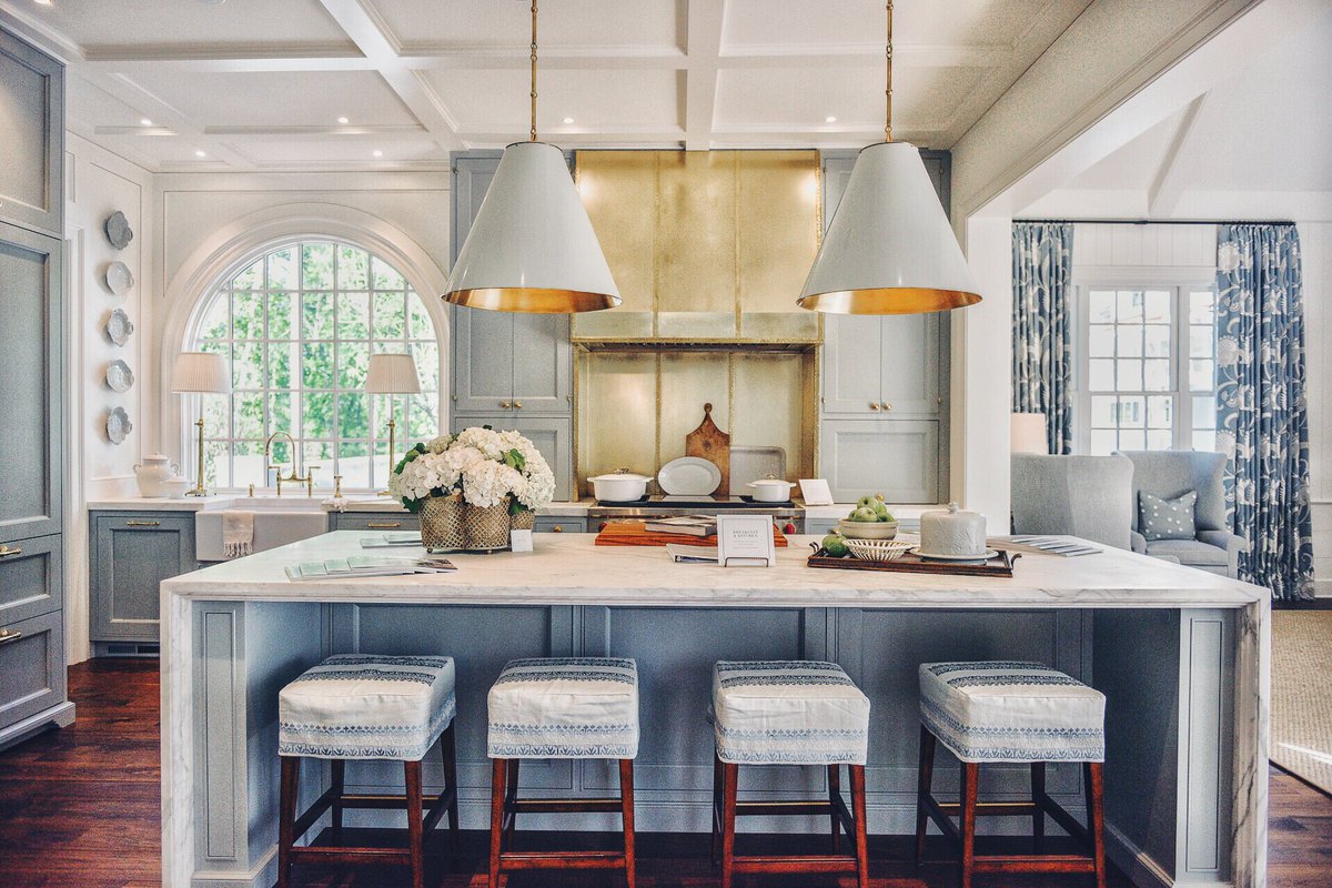 Beautiful light blue kitchen with brass hardware and range hood. Elegant Blue Kitchen Design: What Makes it Timeless?