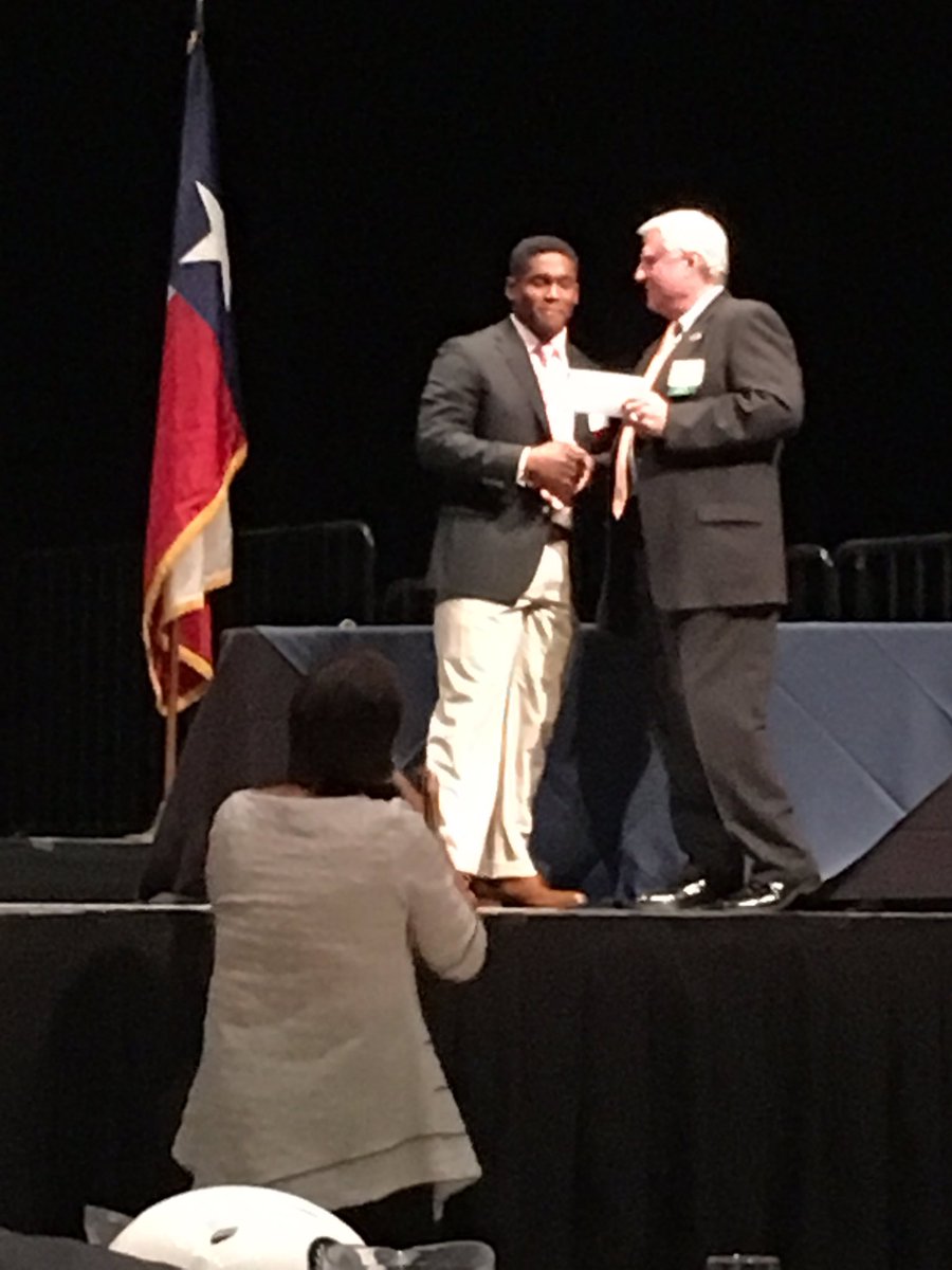 Amon receiving a $1000 scholarship