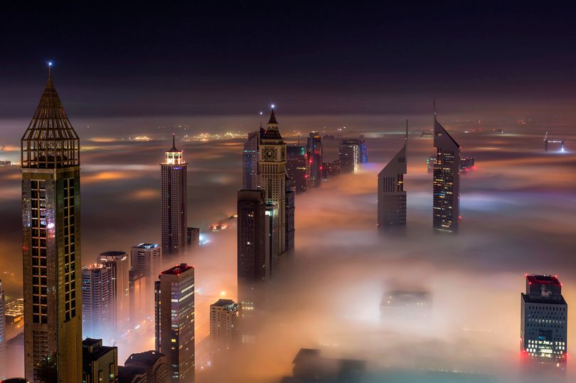 DailyMirror's tweet photo. Dubai skyscrapers peek out from glowing fog as thick winter mist creeps through city  https://t.co/J8S6yVf5cE https://t.co/4m2zn6mH0T