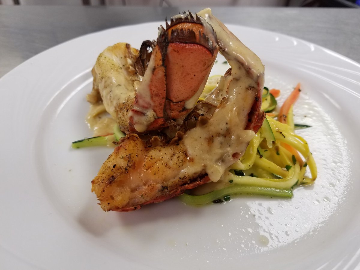 12 Oz lobster topped with newburg sauce set atop a bed of sautéed zucchini, squash and carrots to make every bite as enjoyable as the first